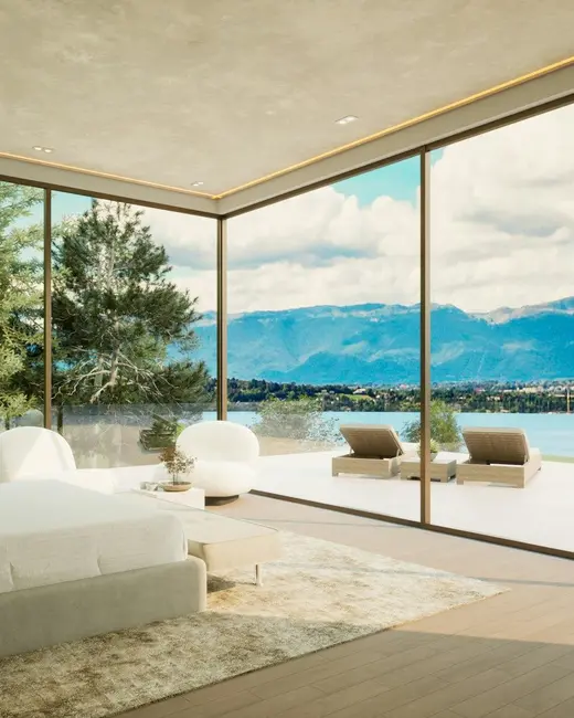 A bedroom with glass walls on two sides opening to a terrace, water and hills beyond.